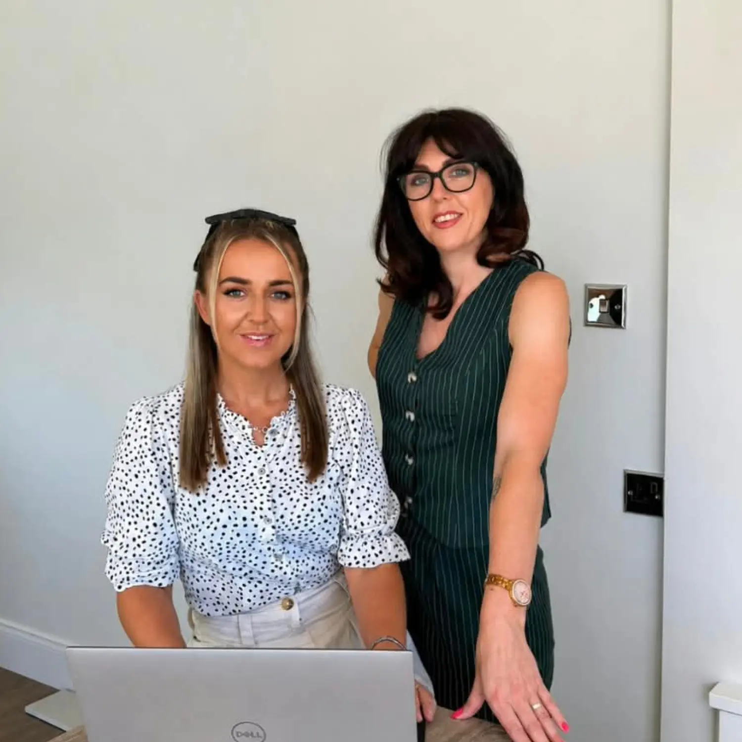 Two Smooth Move conveyancers in conversation at a bright office table